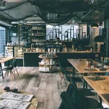 Illustrative photo: tables and a counter in a neighborhood cafe
