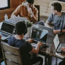 Illustrative photo: colleagues at a shared desk